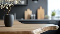 Minimalist kitchen interior with wooden table edge in focus, black matte vase with dried flowers, and blurred dark wall background. Modern scandinavian decor.