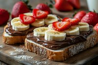 Chocolate spread toast topped with fresh banana slices and strawberries on wooden cutting board. Healthy breakfast or snack concept for food blogs.