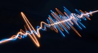 Digital sound wave visualization with glowing orange and blue light trails on dark background for audio technology and music production projects.