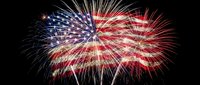Spectacular red white and blue fireworks burst against black night sky creating patriotic display for Fourth of July Independence Day celebration.