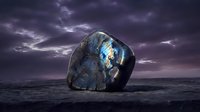 Large labradorite crystal with blue iridescent flashes on dark surface under dramatic purple storm clouds at twilight creating mystical atmosphere.
