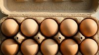 Fresh brown eggs arranged in cardboard carton for cooking and baking ingredients. Organic farm produce for healthy breakfast and culinary preparations.
