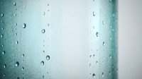 Raindrops and water droplets on glass surface with blurred turquoise and white background, suitable for weather, nature, and atmospheric design projects.