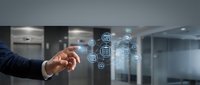 Businessman hand touching digital interface with technology icons in modern office environment representing connectivity and innovation solutions.