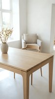 Minimalist dining room interior with wooden table and beige chair near window. Modern Scandinavian home decor with natural light and pampas grass vase.