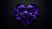 Purple flower petals arranged in heart shape on dark background for romantic design projects and Valentine's Day concepts.