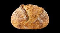 Artisan sourdough bread loaf with crusty golden-brown exterior, isolated on transparent background. Ready for bakery designs, food packaging, menus, t-shirts, and print-on-demand products.