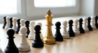 Golden chess king piece standing prominently among black and white pawns on wooden surface, symbolizing leadership, strategy and business hierarchy.