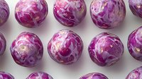 Fresh purple and white marbled cabbage heads arranged in neat rows on white background, creating geometric pattern. Organic vegetables isolated for food design.