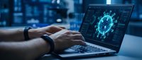 Hands typing on laptop displaying coronavirus molecule structure in modern office environment for medical research and pandemic analysis.