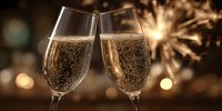 Champagne glasses toasting with sparkling wine against festive bokeh background with golden sparkler light. Celebration concept for holidays and special occasions.
