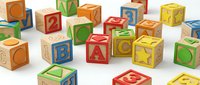 Colorful wooden alphabet blocks scattered on white background featuring letters and numbers for educational play and learning activities.