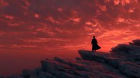 Silhouette of lone figure standing on rocky cliff edge against dramatic crimson sunset sky with textured clouds.