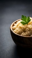 Cooked fusilli pasta in wooden bowl garnished with fresh parsley on dark slate background for culinary presentations and recipe blogs.