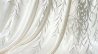Soft white draped fabric with delicate leaf shadow overlay, creating an elegant, minimalist aesthetic for backgrounds and design projects.