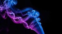 Colorful smoke swirls in blue and purple hues creating abstract flowing patterns against black background for modern digital art and creative projects.