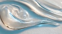 Abstract fluid art with swirling silver and blue metallic paint creating dynamic wave patterns on white surface. Suitable for modern interior design.