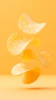 Crispy potato chips floating and falling on orange background, minimalist food photography composition for snack advertising and menu design.