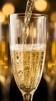 Champagne pouring into flute glass with bubbles and golden bokeh background, perfect for celebration, toast, and festive event designs.