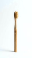 Natural bamboo toothbrush isolated on white background for eco-friendly dental care and sustainable oral hygiene products.