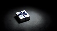 White gift box with blue ribbon bow on dark surface, suitable for holiday, birthday, and celebration marketing materials.