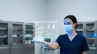 Female healthcare professional with South Asian ethnicity wearing surgical mask and navy scrubs interacting with holographic health data visualization in modern medical laboratory setting.