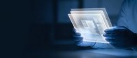 Engineer or technician with gloved hands examining transparent holographic interface displaying digital blueprint or technical schematic in dark workspace for industrial design and technology concepts.
