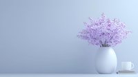 Minimalist composition with delicate purple flowers in white ceramic vase against light gray wall, with coffee cup and stacked books, creating serene atmosphere.