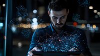 Young businessman working late at night with futuristic holographic data visualization and network connections projected from digital tablet.