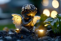 Dreamy garden angel figurine with glowing wings against bokeh lights at dusk, creating magical atmosphere in garden setting. Decorative cherub statue rests peacefully on soil.