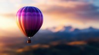 Vibrant purple and orange hot air balloon floating against dramatic sunset sky with mountain silhouettes, creating dreamy atmospheric scene for travel and adventure concepts.
