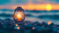 Vintage oil lantern glowing warmly on rocky beach at sunset with ocean waves and golden sky creating peaceful evening atmosphere for camping and outdoor adventures.