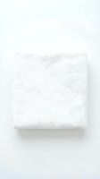 Soft white folded terry towel isolated on white background, showcasing clean fluffy texture for spa, hotel, and bathroom concepts.