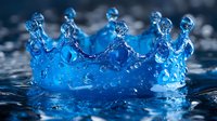 Crown-shaped water splash with droplets frozen in time against dark background, bright blue liquid creating royal crown formation in high-speed macro photography.