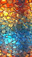 Abstract mosaic pattern with vibrant gradient from fiery orange to deep blue, featuring cracked glass effect perfect for modern design backgrounds, wallpapers and artistic projects.