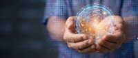 Businessman holding glowing digital globe with network connections, representing global business, technology innovation, and worldwide digital communication for corporate concepts.