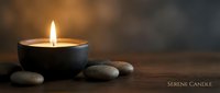 Burning candle with smooth stones on wooden surface creating peaceful spa atmosphere for relaxation and meditation wellness concepts.