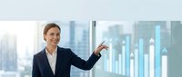 Professional businesswoman presenting financial data charts and graphs in modern office environment for corporate presentations and business analytics.
