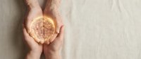 Hands holding glowing brain with network connections representing artificial intelligence, innovation and mental health awareness on neutral background.