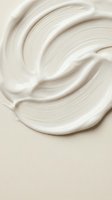 Creamy white cosmetic texture with smooth swirl pattern for skincare and beauty product backgrounds.