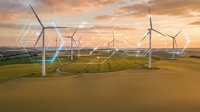 Aerial view of wind turbines in rural landscape at golden hour sunset, renewable energy farm generating sustainable power.