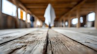 Mysterious figure in white cloth walking through rustic wooden corridor with natural light streaming through windows, creating atmospheric perspective.