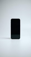 Black smartphone with blank screen isolated on white background, suitable for app mockups, mobile technology presentations, and digital device advertising.