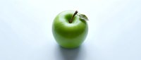 Fresh green apple with stem isolated on white background, suitable for healthy eating, nutrition, and food design projects.