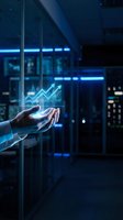 Hand holding glowing upward trending arrow chart in futuristic digital environment with blue neon lights and data analytics interface for business growth and financial success concepts.