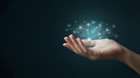 Hand holding glowing digital network with connected icons and data nodes on dark background, representing technology, connectivity, innovation, and digital transformation for business solutions.