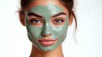 Young woman with green clay facial mask treatment on white background, showcasing skincare and beauty routine for cosmetic product advertising.