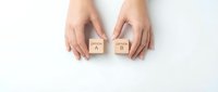 Female hands holding wooden blocks with letters A and B on white background for decision making and choice concepts.