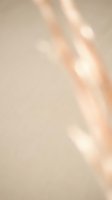 Soft beige abstract background with warm light rays and gentle shadows creating elegant minimalist texture for modern design projects.