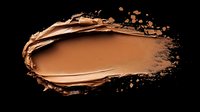 Brown foundation makeup smear with scattered powder particles isolated on black background for cosmetic advertising and beauty product design.